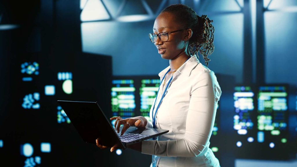 cyber security practices, female IT technician using a laptop