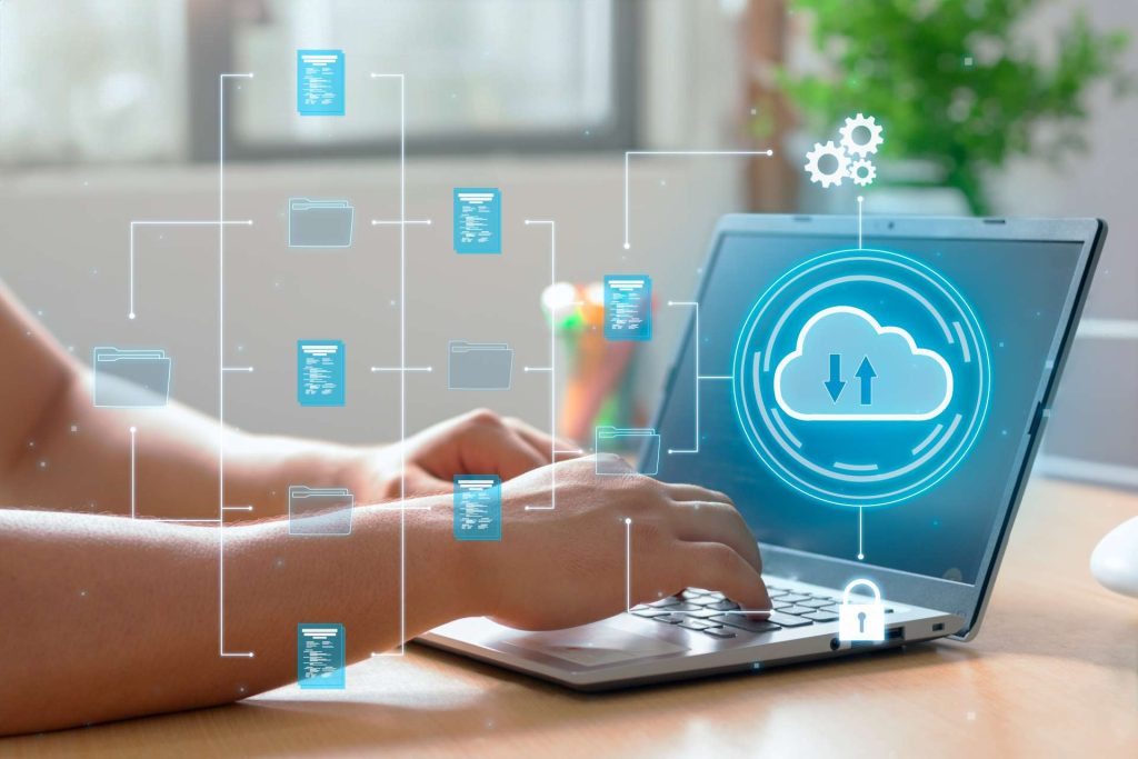 cloud management platform, person typing on laptop with cloud network graphic overlayed