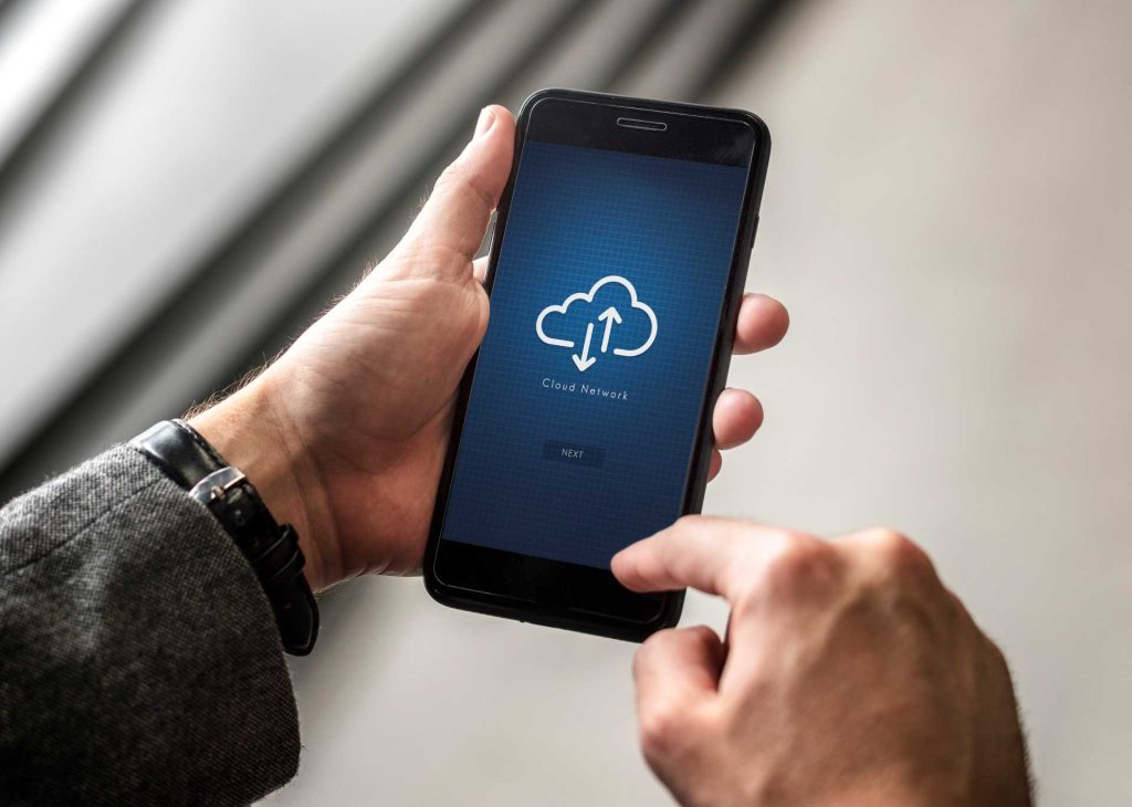 cloud migration strategy, close up of phone with cloud network graphic
