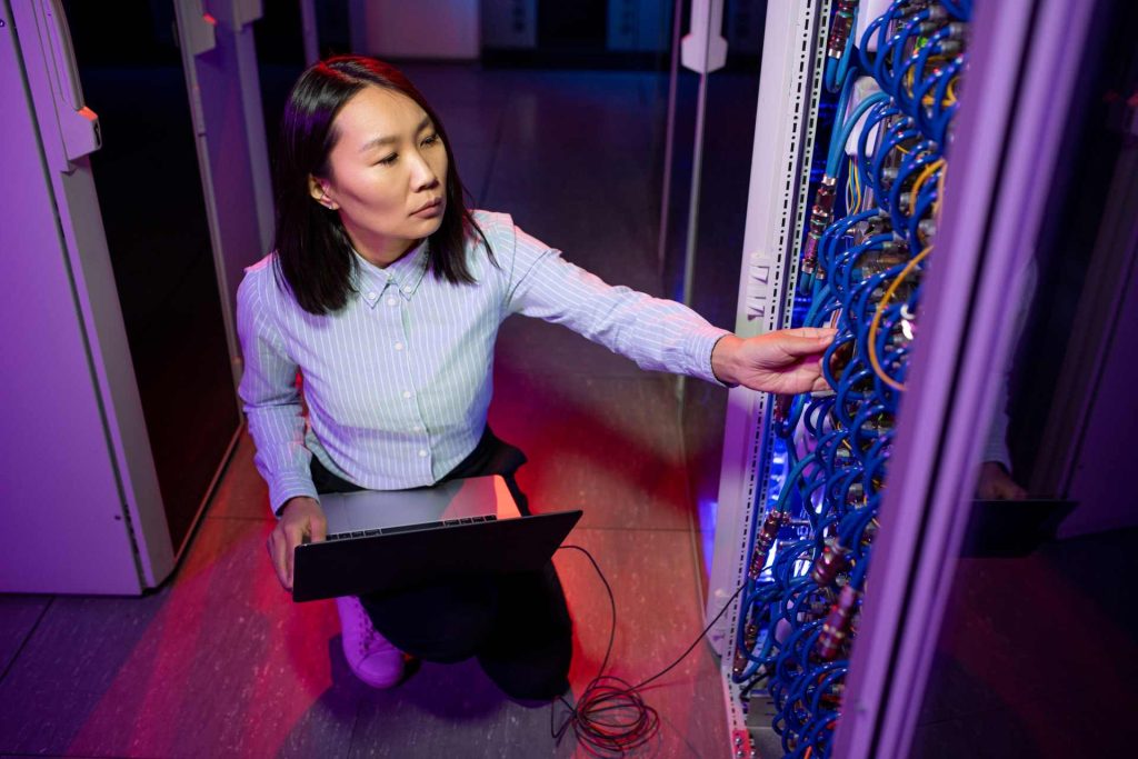edge computing, woman inspecting servers